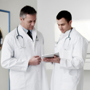 Two doctors looking at a notepad