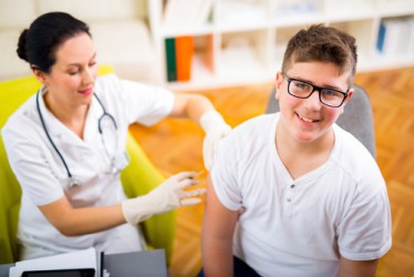 Child being vaccinated by a nurse